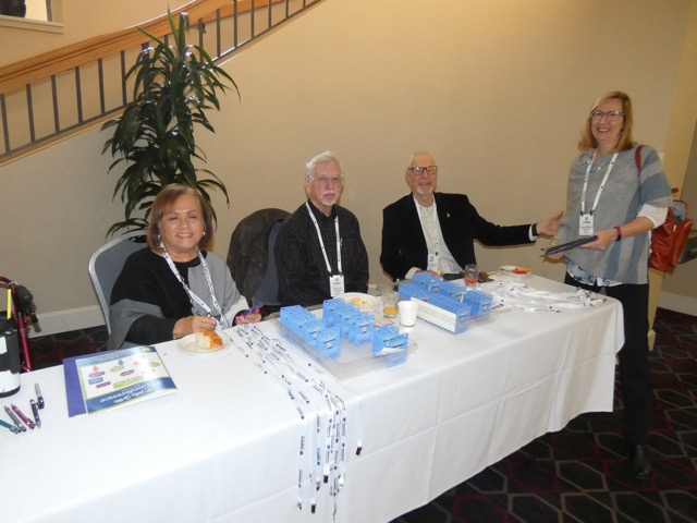 Registration Desk with Judy Lussie, Gary Lea, and Art Tenbrink